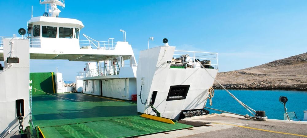 Car ferry boat with open ramp waiting for boarding